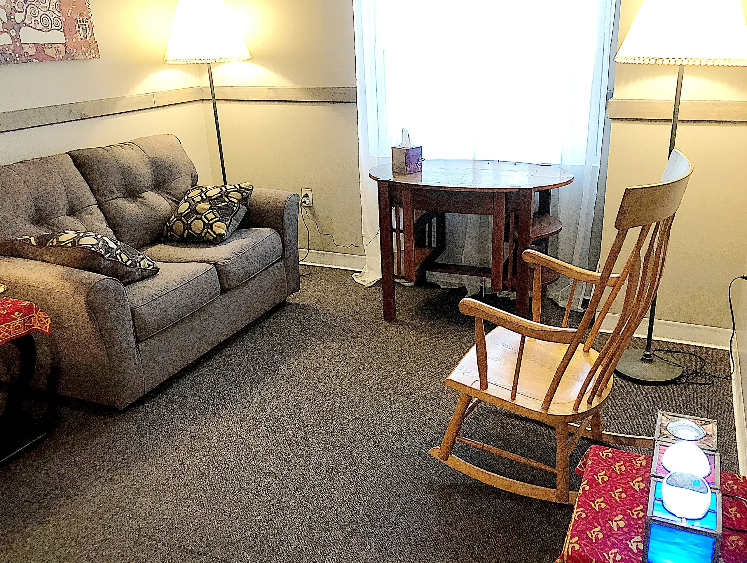 A comfortable seating arrangement, including a rocking chair, for relaxed client-focused counseling.
